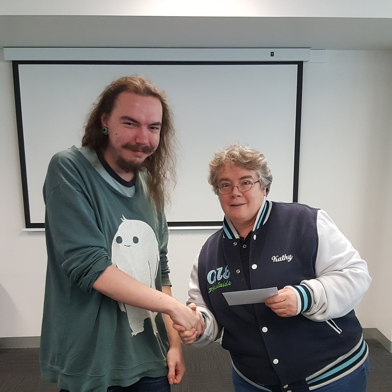 Kathy presenting prize envelope to Edee Korhonen-Bannister.