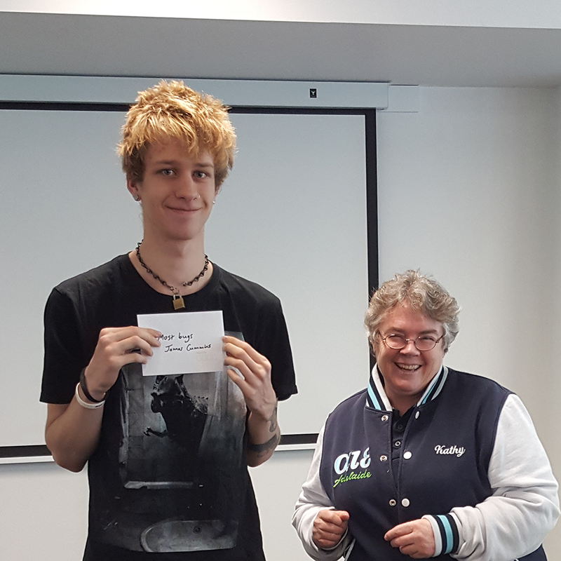 Kathy presenting prize envelope to James Cummins.