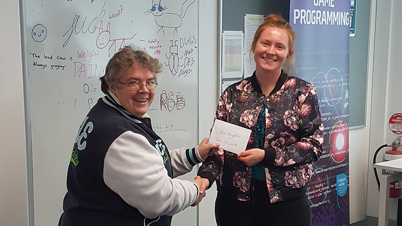 Kathy presenting prize envelope to Tessa Touchette.