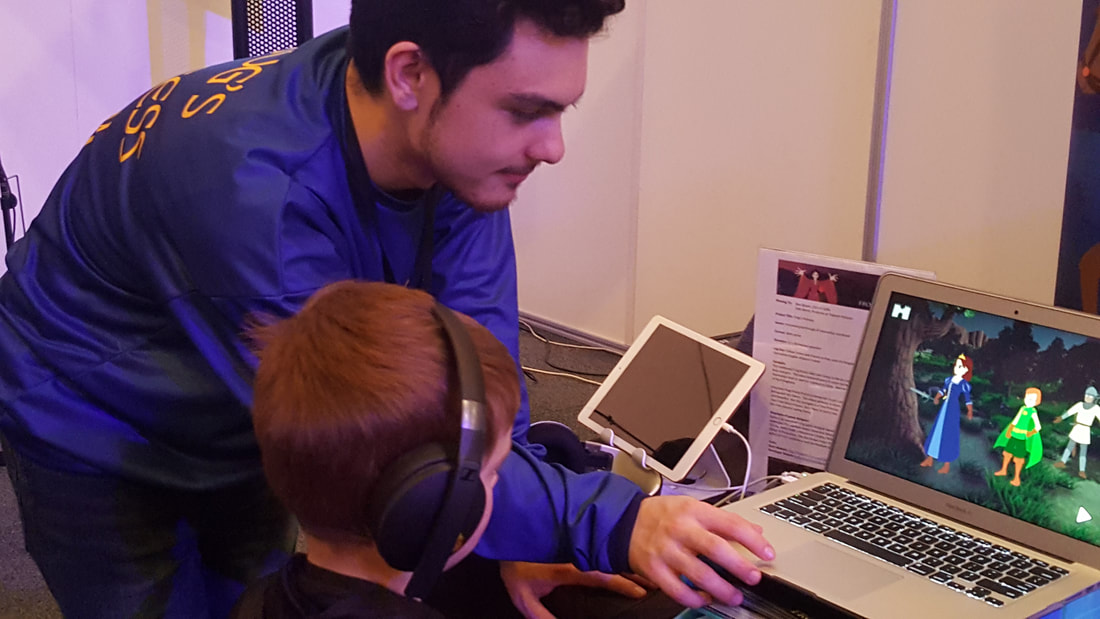 Sebastian Demoulin with 5-year-old player at AVCon Indie Games Room