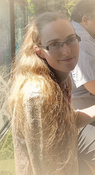 Christy Butt looking at the camera with golden hair down to her elbows.