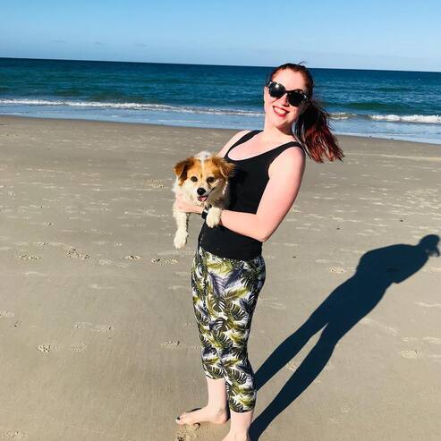 Carolyn at the beach holding Holly