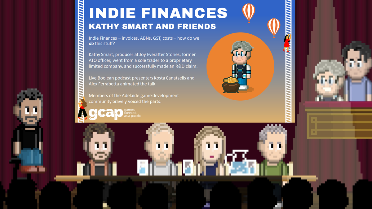 4 people sit at a table on a stage with glasses of water and theatre curtains closed behind them.  On one side an interviewer sits on a stool.  On the other side two more people stand.  Above their heads is a powerpoint presentation saying Indie Finances, Kathy Smart and Friends, with a talk summary